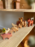 Holztiere Bauernhof 11-teilig von Decor Spielzeug, alle Tiere auf einem Regalbrett