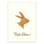 Postkarte Frohe Ostern von Corinna Schwerdtfeger A6: ein Hase in Brauntönen als Aquarell auf cremefarbenem Naturkarton, Schriftzug Frohe Ostern