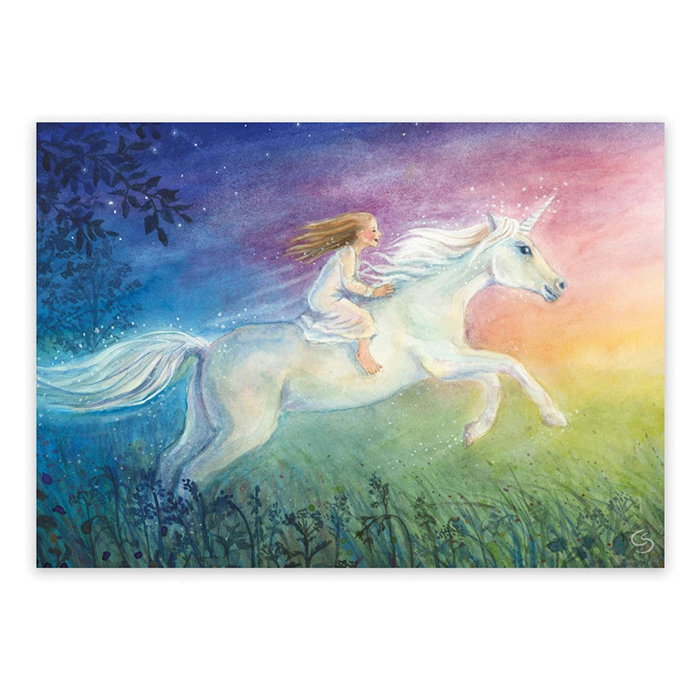 Postkarte Mein Einhorn von Corinna Schwerdtfeger A6: ein Kind mit langem Haar reitet auf einem weißen Einhorn über die Wiese, der Himmel leuchtet in Morgenfarben