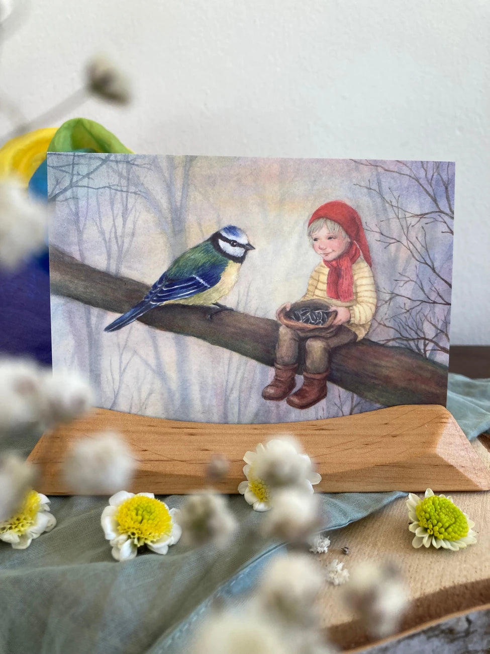 Postkarte Wichtel mit Blaumeise von Corinna Schwerdtfeger A6 auf einem Holzständer dekoriert, Foto