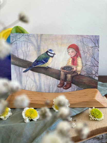 Postkarte Wichtel mit Blaumeise von Corinna Schwerdtfeger A6 auf einem Holzständer dekoriert, Foto