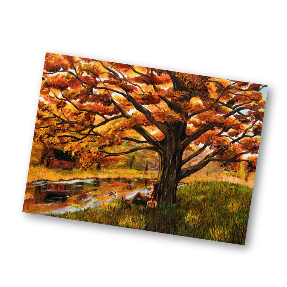 Postkarte Herbstbaum von Esther Bennink A6: ein großer Baum mit orangem Herbstlaub am Wasser