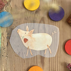 Hannahs Firlefanz Bügelbild Schwein mit Blume im Maul, auf Holz zwischen bunten Holzscheiben