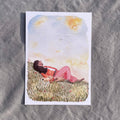 Postkarte Head in the Clouds von Hannahs Firlefanz A6, Person liegt mit Hund im Gras und schaut in den Sommerhimmel