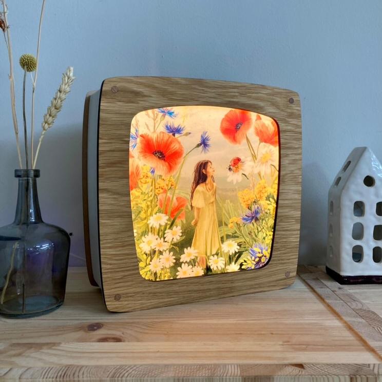 Motiv Bewunderung von Iris Esther für die magische Lampe: Gestalt im gelben Kleid in einer Sommerwiese mit rotem Mohn und Kornblumen