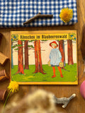 Bilderbuch Hänschen im Blaubeerenwald von Elsa Beskow 2. Hand, Cover mit Hänschen und zwei Körben im Kiefernwald, Foto