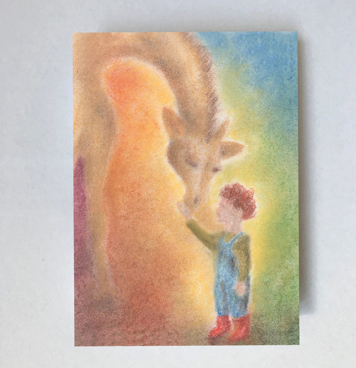 Postkarte Giraffe von Lot Bouwes A6: eine Giraffe beugt ihren langen Hals zu einem Kind hinunter, warmes Licht