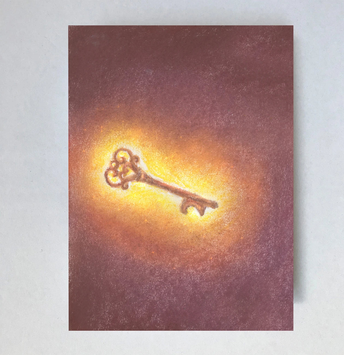Postkarte Schlüssel von Lot Bouwes A6: ein goldener, verzierter Schlüssel leuchtet im dunklen Rotbraun