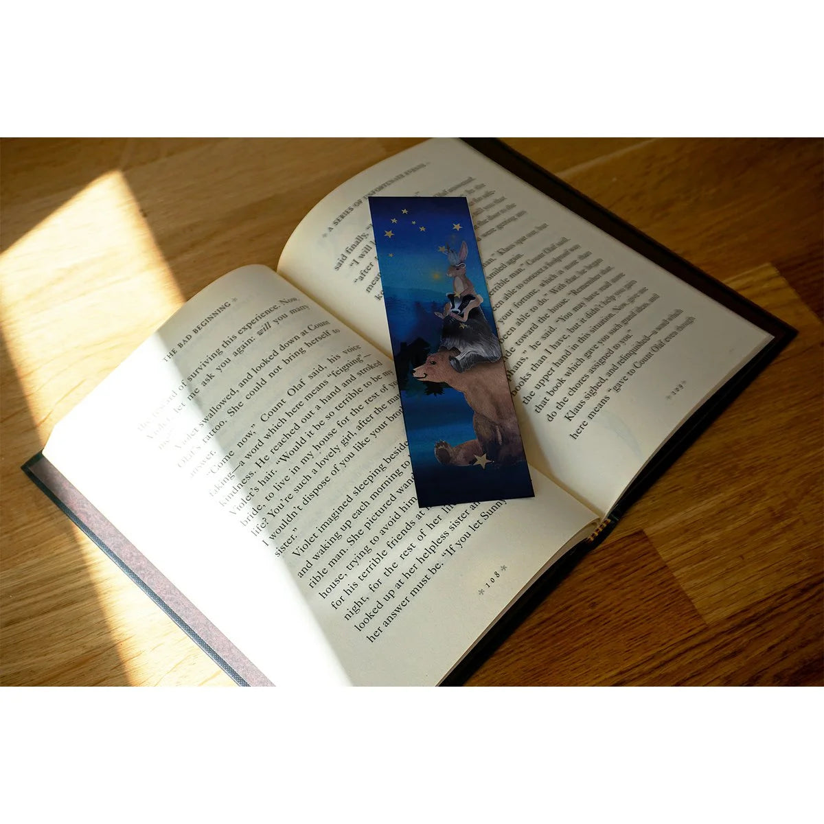 Lotte Drouen Lesezeichen Sterne aufhängen, Rückseite mit Bär, Dachs und Hase übereinander unter dem Sternenhimmel, auf einem aufgeschlagenen Buch